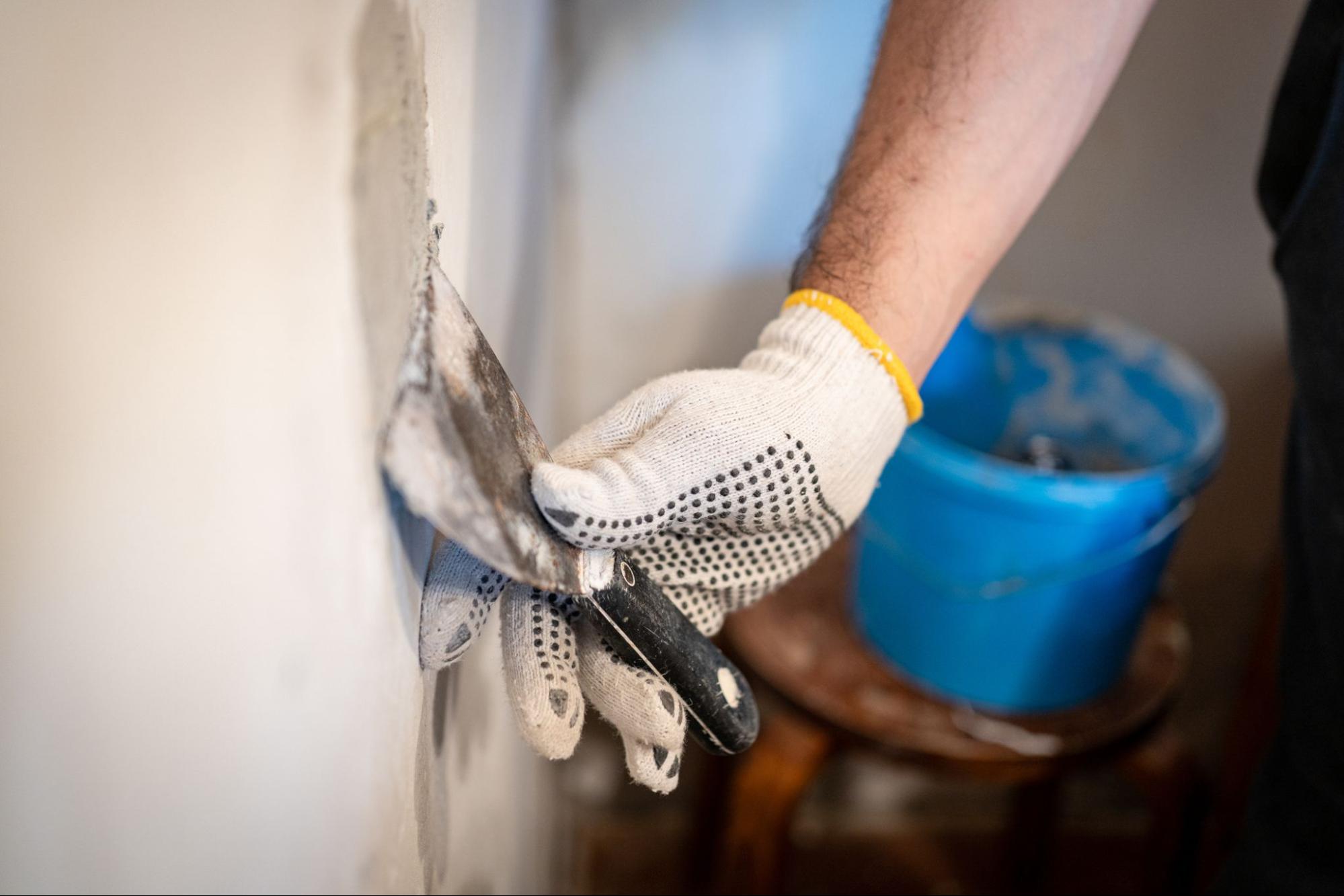 person patching drywall